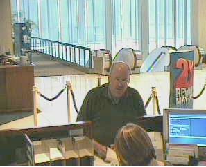 Low-key balding dude walks off with purloined cash.