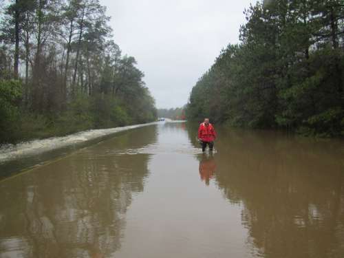 US Geological Survey scientist Jimmy Hopkins takes a stream stream flow measure in Bon Wier, Texas, during the March 2016 flooding. USGS photo by Jody Avant & Jeff East
